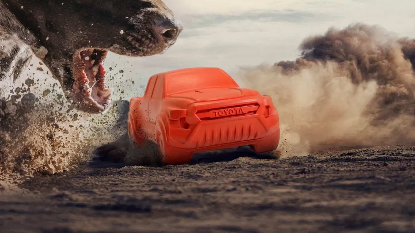 a rubber toy truck evading a dog